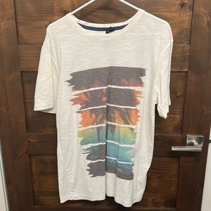 White t-shirt with sunset graphic, size large
